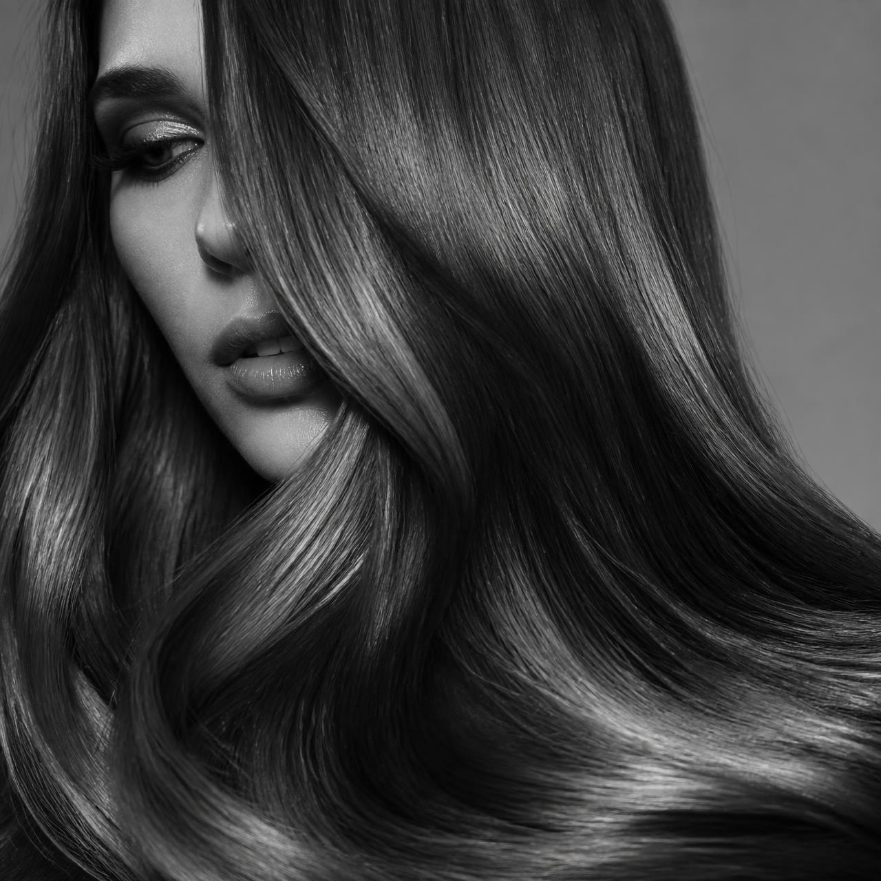 Close-up of glossy styled hair after a Sur Mesure Salon blowout